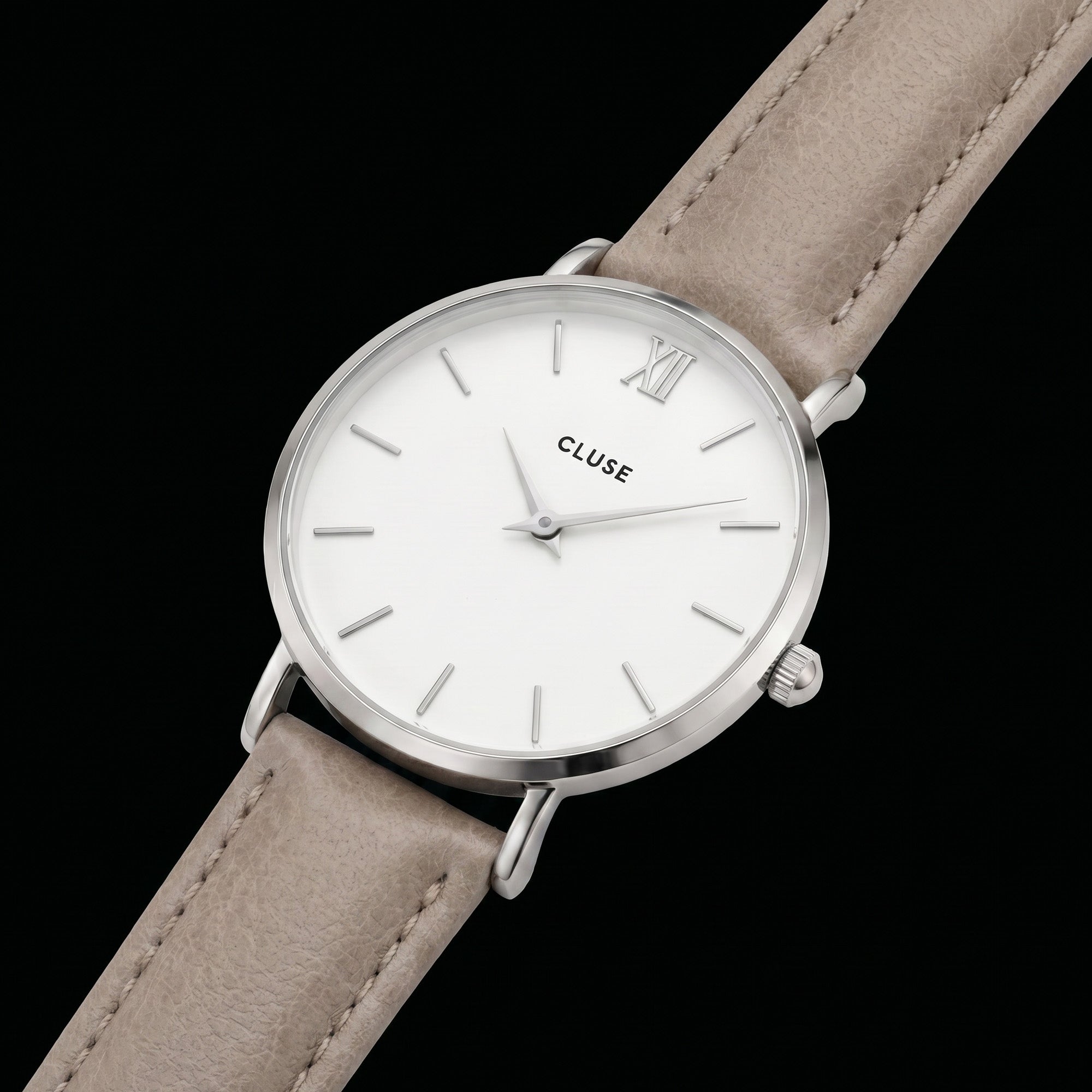 Close-up of Cluse Minuit silver/white doe brown watch.
