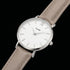 Close-up of Cluse Minuit silver/white doe brown watch.