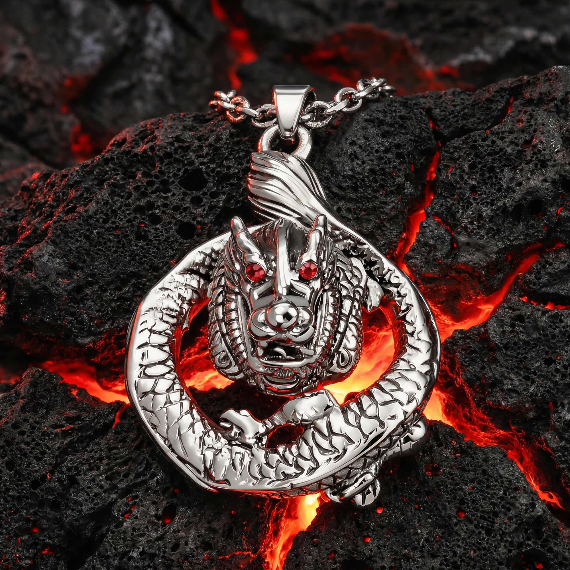 Coiled dragon stainless steel necklace laying on black volcanic rock with a red lava glow underneath.