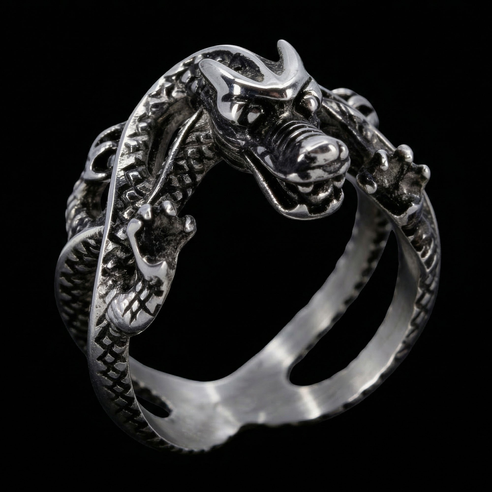 Angle side view of a coiled dragon men's stainless steel ring.