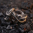Coiled dragon men's stainless steel ring on hot coals.