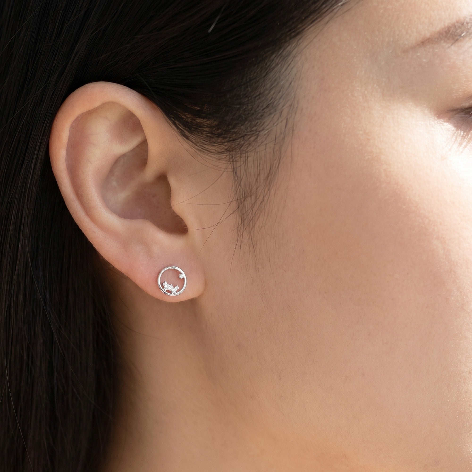 Woman wearing Engelsrufer cosmo circle CZ earrings.