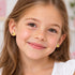 A young girl wearing daisy ladybird enamel children’s sterling silver earrings.