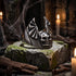Death bat skull wings stainless steel men's ring in a dungeon with cobwebs and candles.
