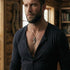 Man inside a wood cabin wearing a sterling silver dragon tooth pendant.