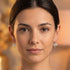 Woman wearing a pair of Engelsrufer dragonfly filigree silver hook earrings.