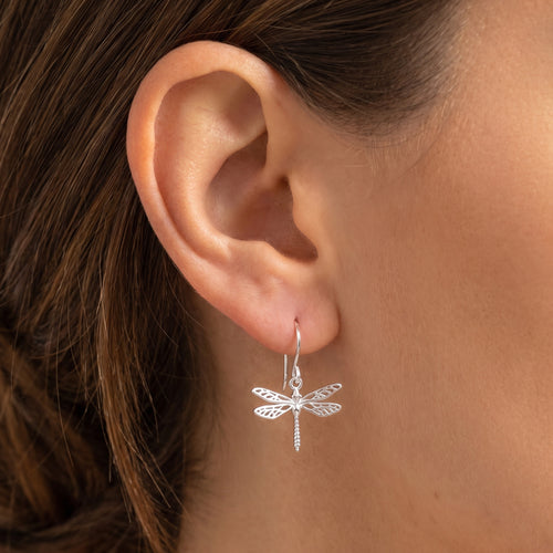 Woman wearing Engelsrufer dragonfly filigree silver hook earrings.