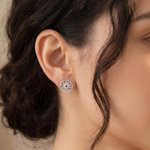Woman wearing Engelsrufer dreamcatcher sterling silver stud earrings.