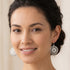Woman wearing Engelsrufer dreamcatcher sterling silver hook earrings.