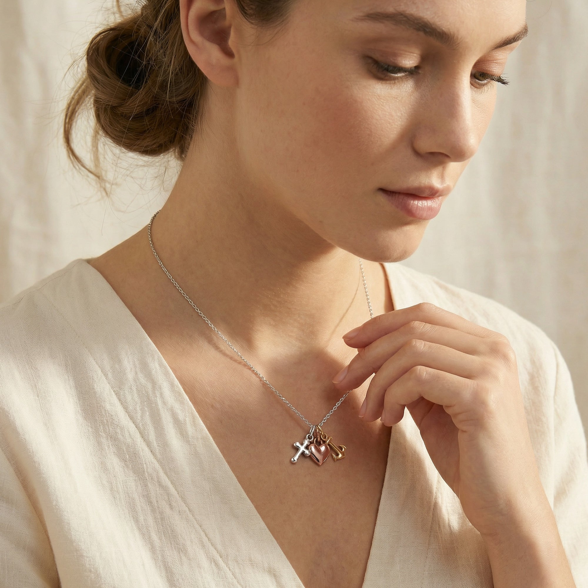 Woman wearing an Engelsrufer Faith Love & Hope Sterling Silver Necklace. 