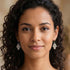 Woman wearing Engelsrufer Fatima’s Hand silver hook earrings.