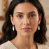 Woman wearing Engelsrufer feather sterling silver dangle earrings.
