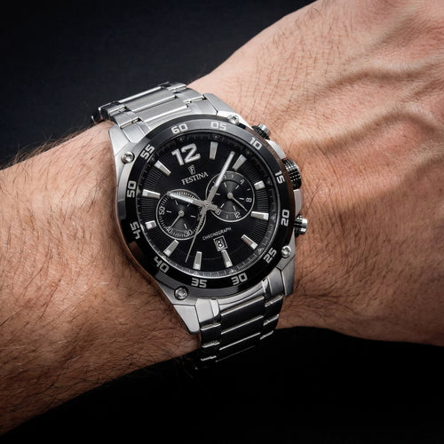 Man wearing Festina black dial chronograph date watch.
