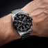 Man wearing Festina black dial chronograph date watch.