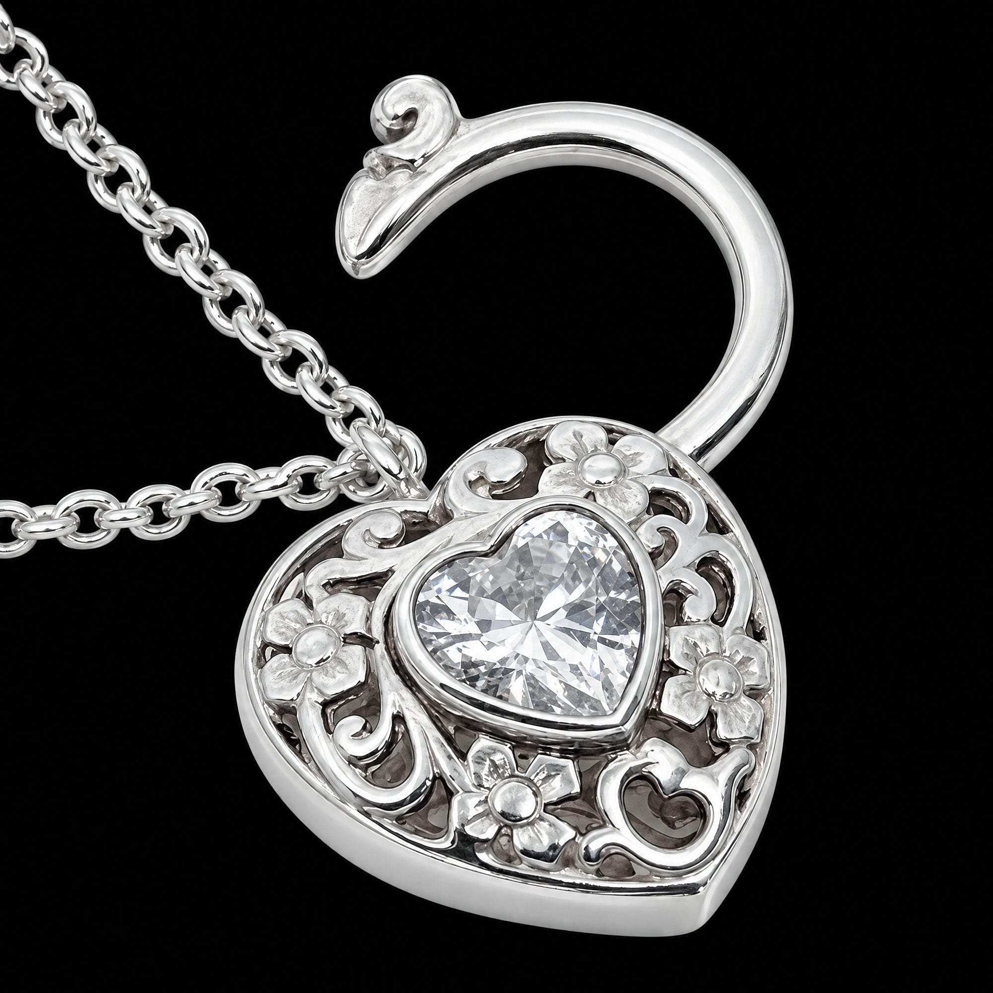 Close-up of the front of a filigree heart padlock CZ sterling silver belcher chain bracelet.