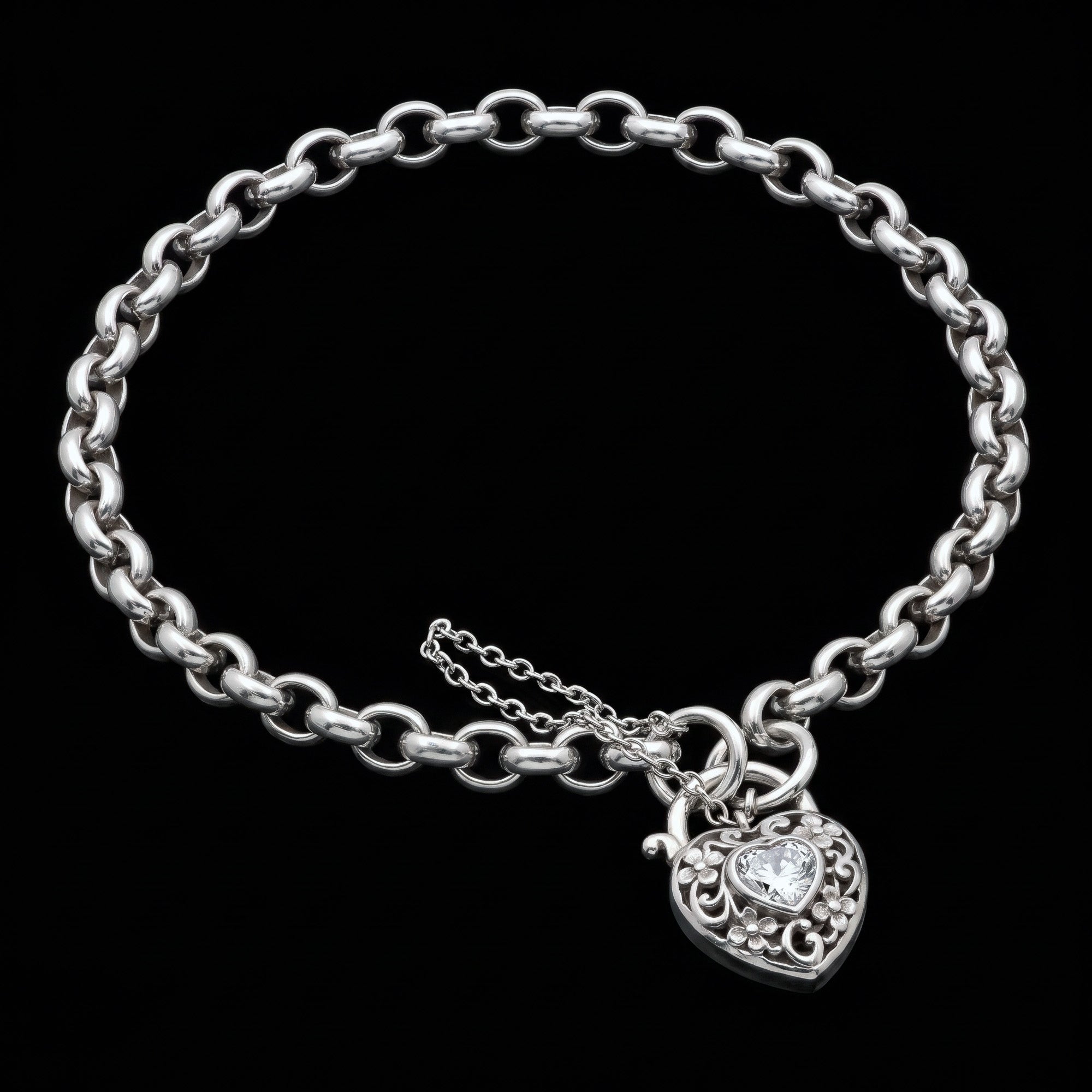 Side view of a filigree heart padlock CZ sterling silver belcher chain bracelet.