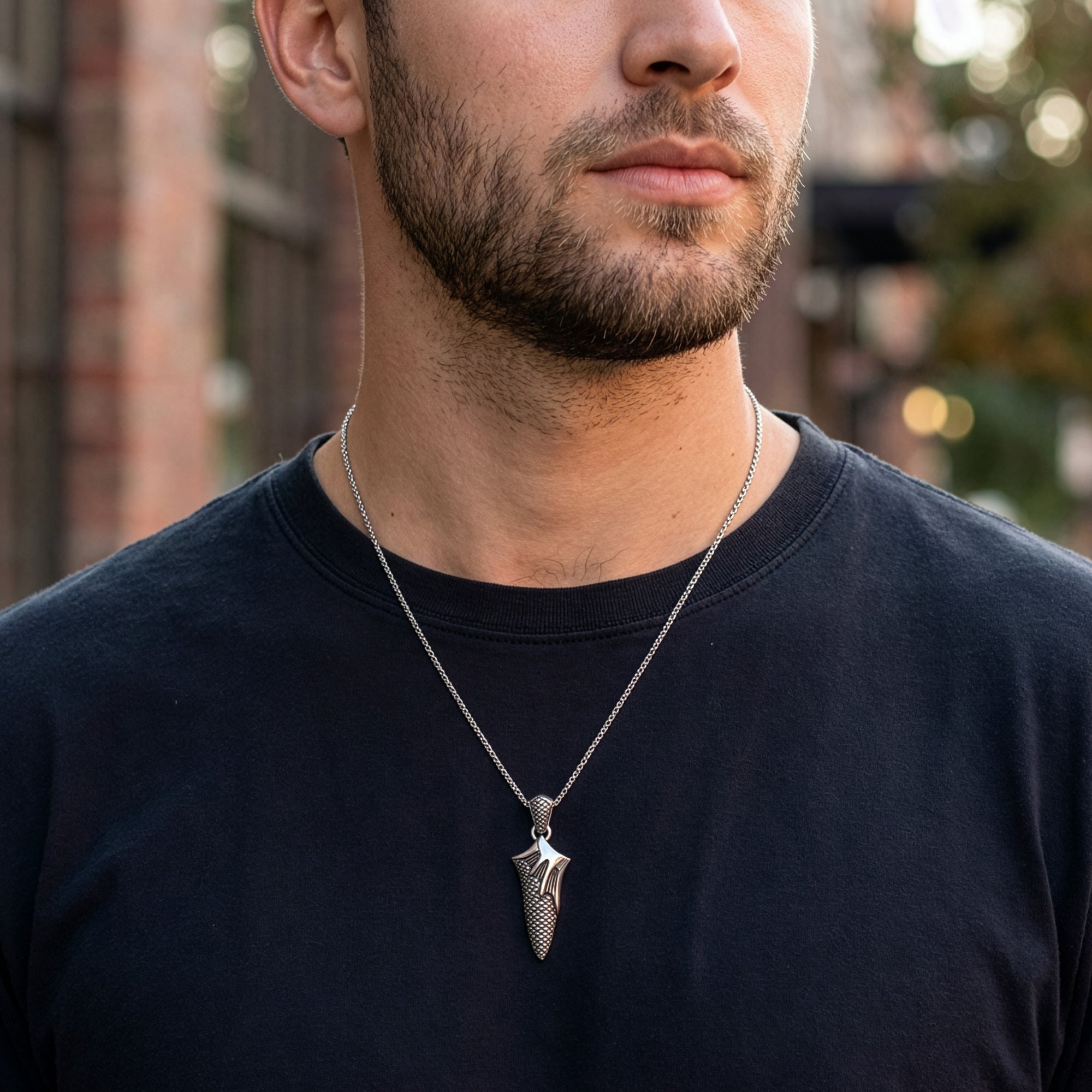 Man wearing flaming dagger stainless steel necklace.