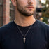 Man wearing flaming dagger stainless steel necklace.