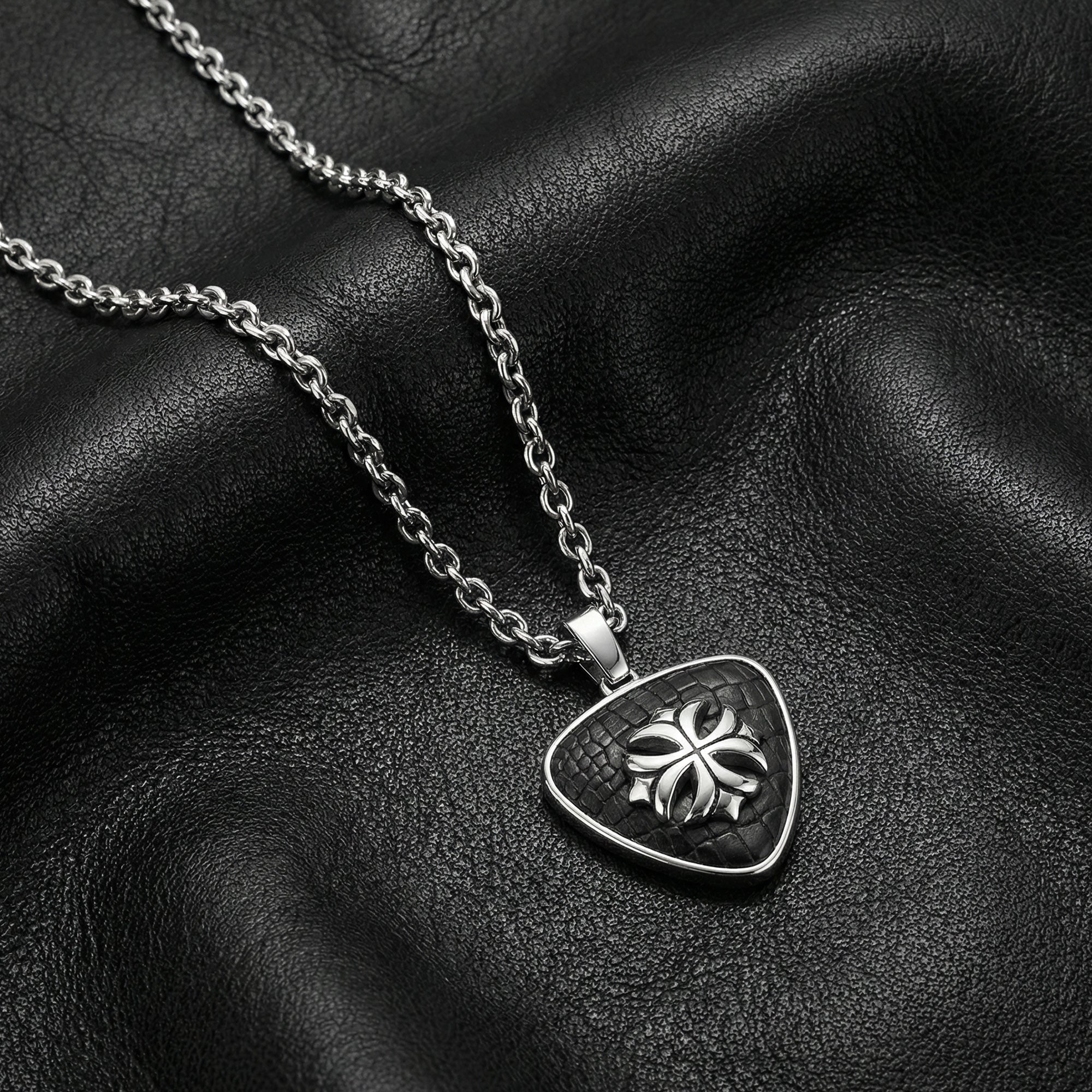 Stainless steel fleur-de-lis cross medallion necklace on black leather.