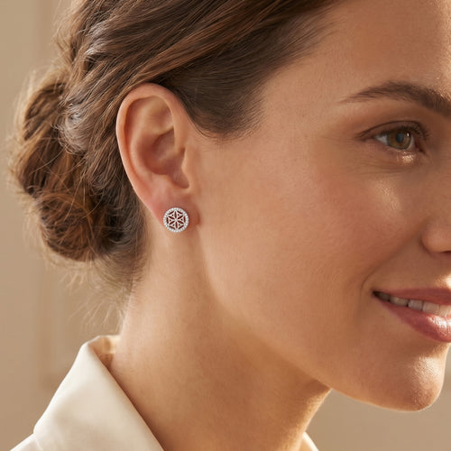 Woman wearing Engelsrufer flower of life silver circle earrings.