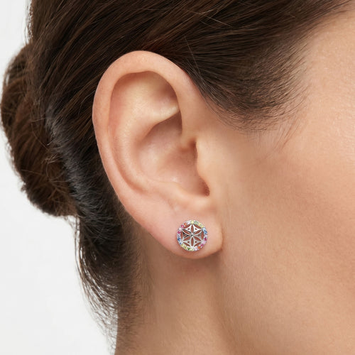 Woman wearing Engelsrufer flower of life rainbow cz silver circle earrings.