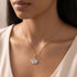 Woman wearing an Engelsrufer ginkgo leaf rose gold silver necklace.