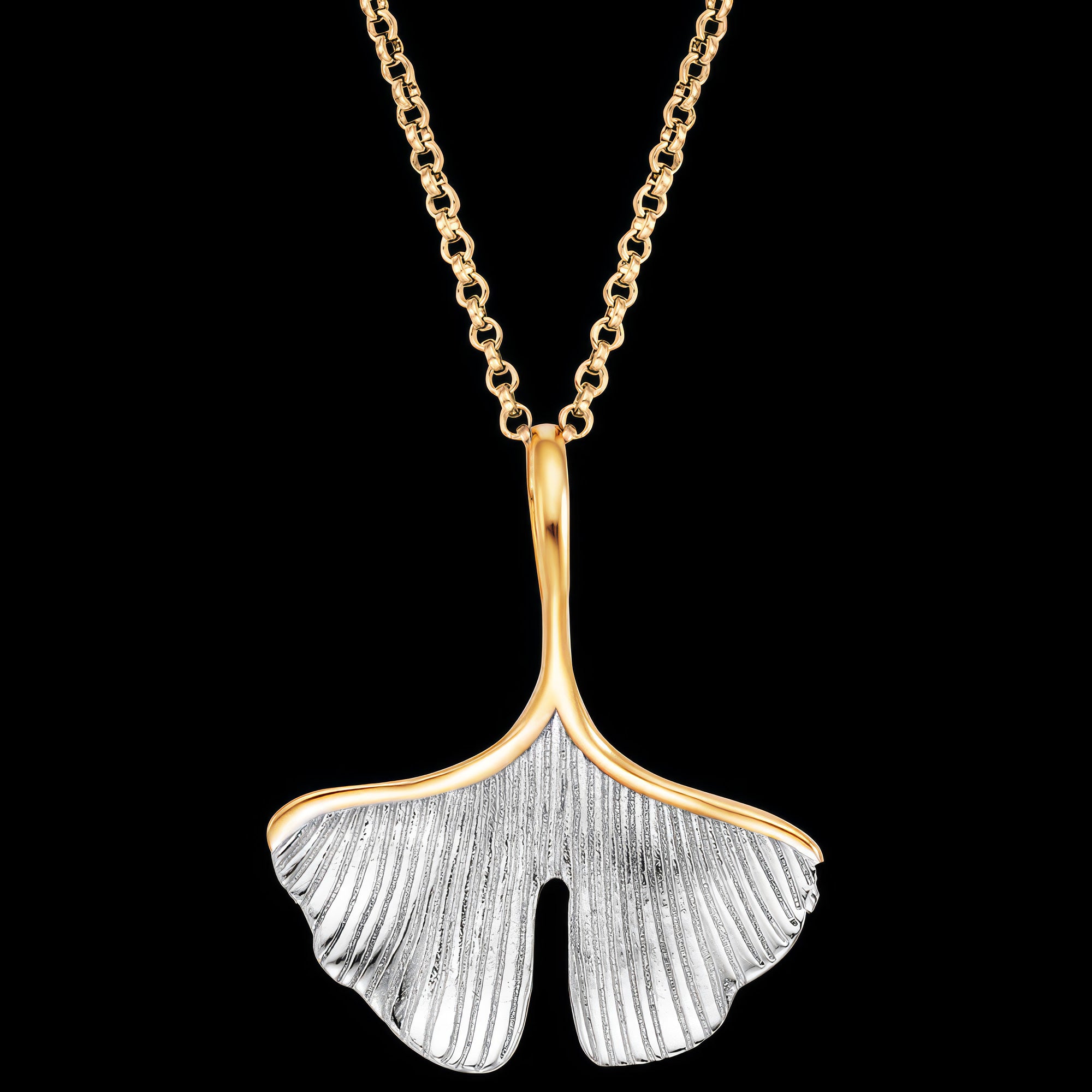 Close up of an Engelsrufer ginkgo leaf gold silver necklace.