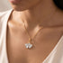 Woman wearing an Engelsrufer ginkgo leaf gold silver necklace.