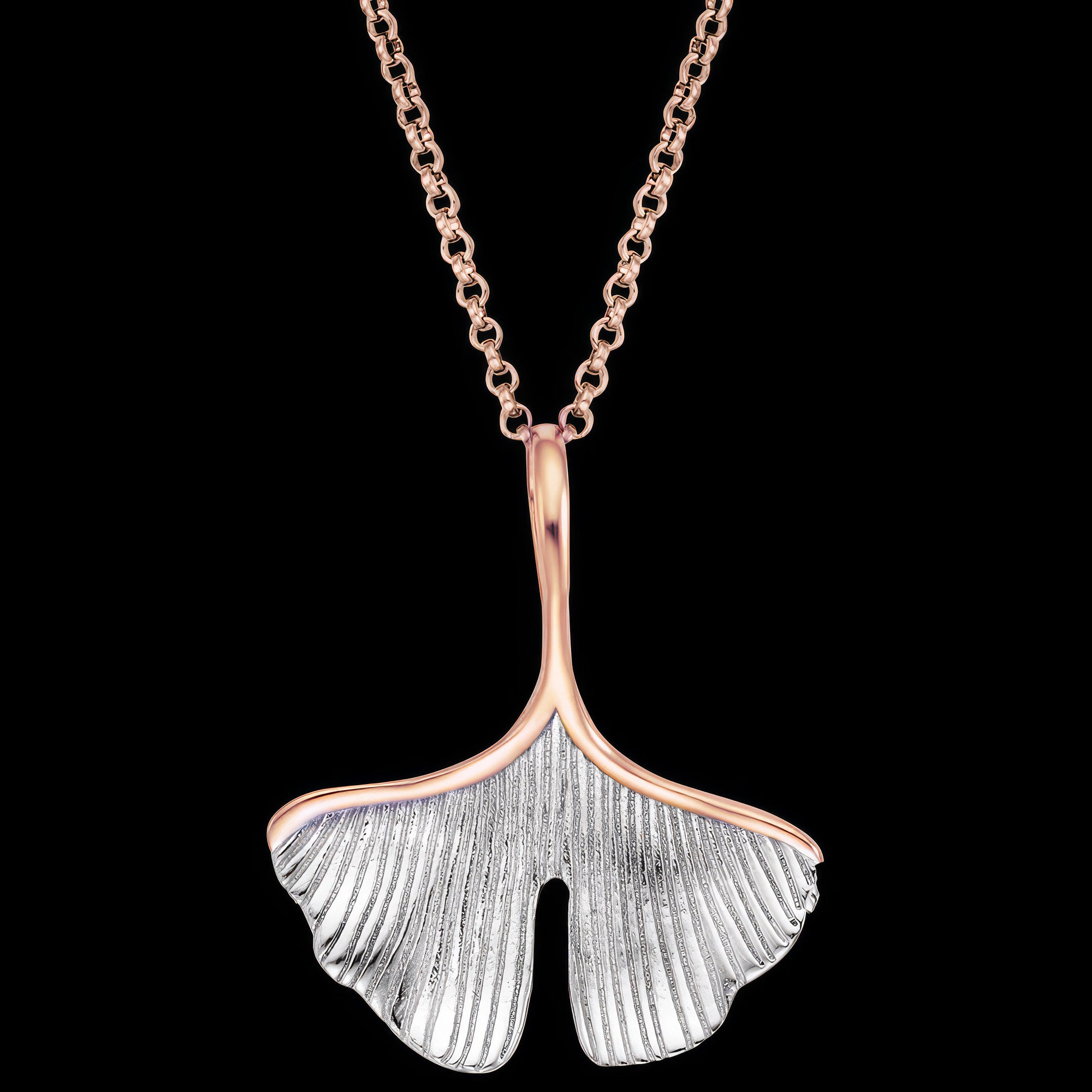 Close up of an Engelsrufer ginkgo leaf rose gold silver necklace.