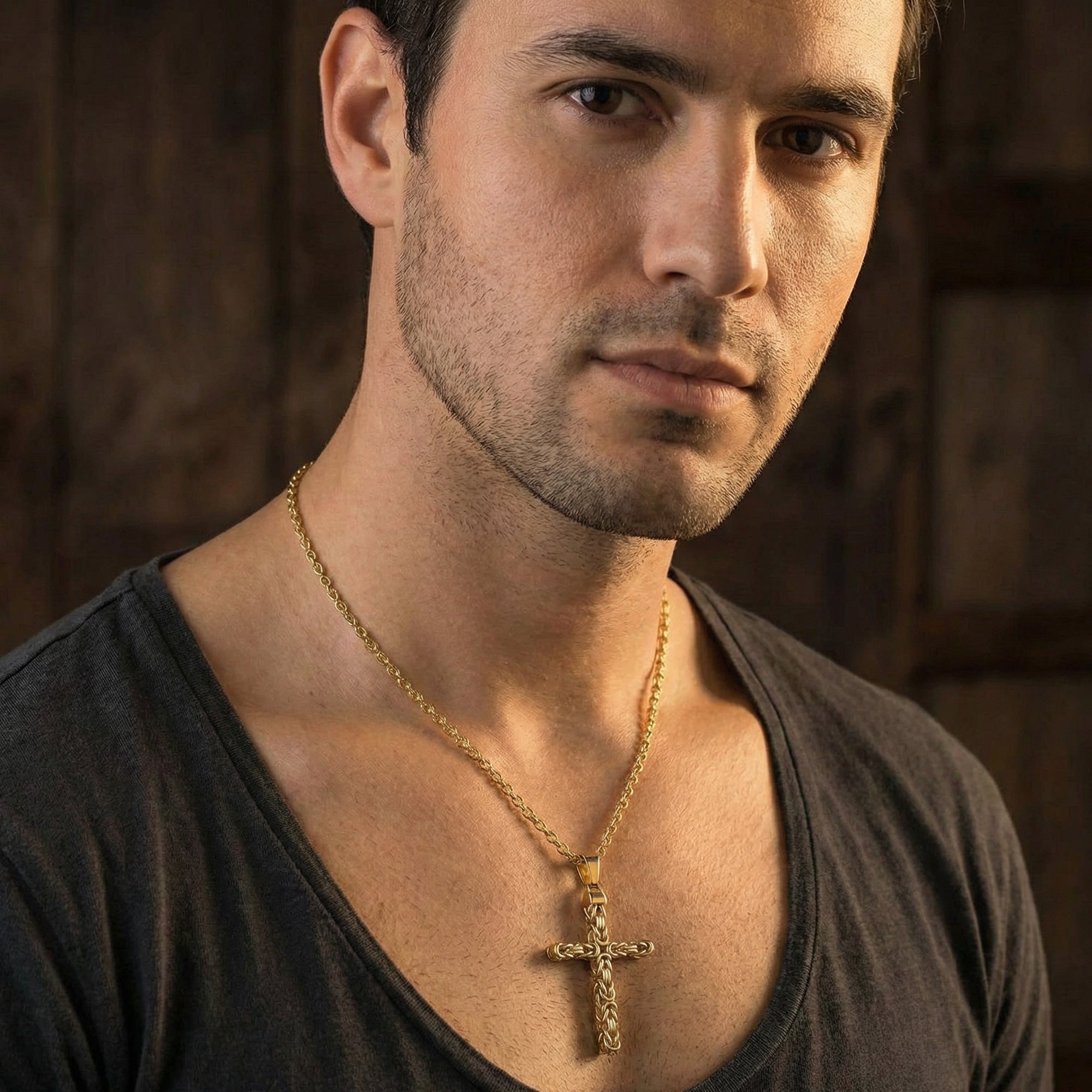 Man wearing Byzantine rope knot cross gold stainless steel necklace.