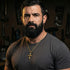 Bearded man in a t-shirt wearing barbed cross gold steel necklace.