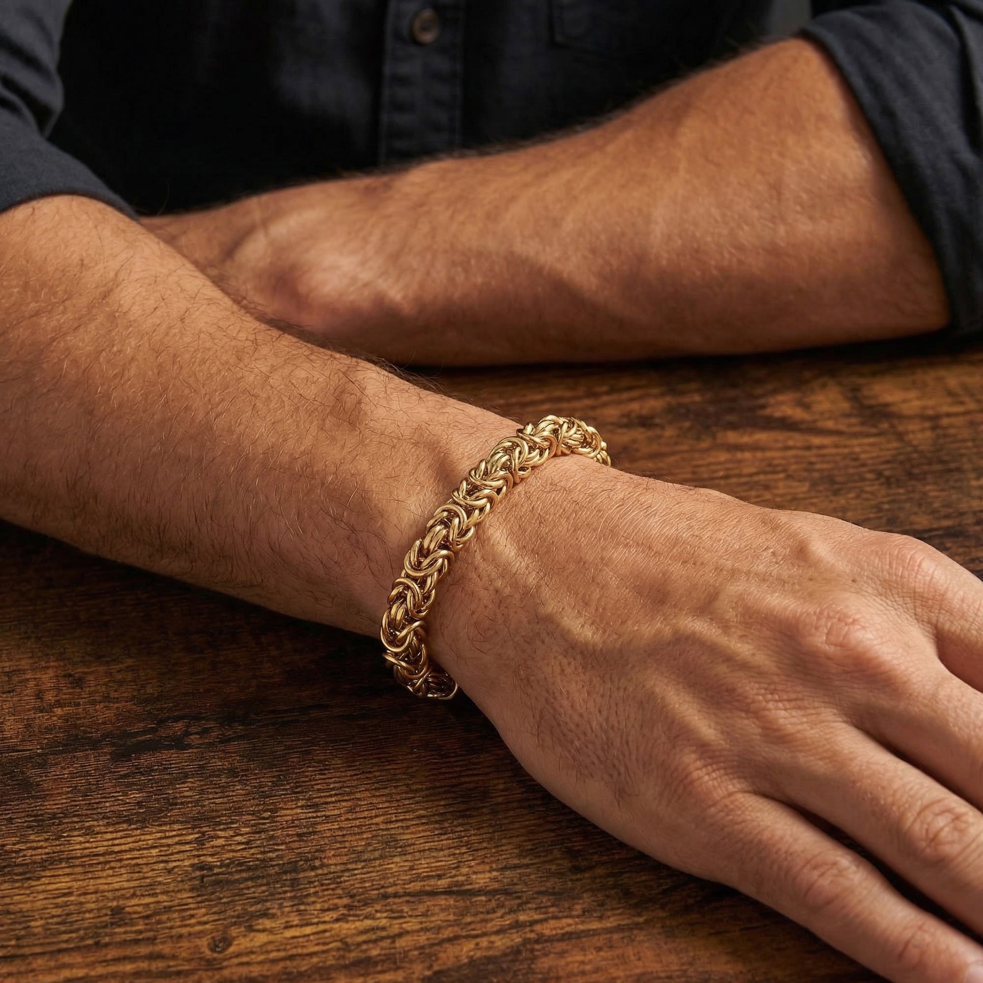 Man wearing Save Brave byzantine chain men's gold steel bracelet on his wrist.