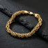 Byzantine chain men's gold steel bracelet on black slate.