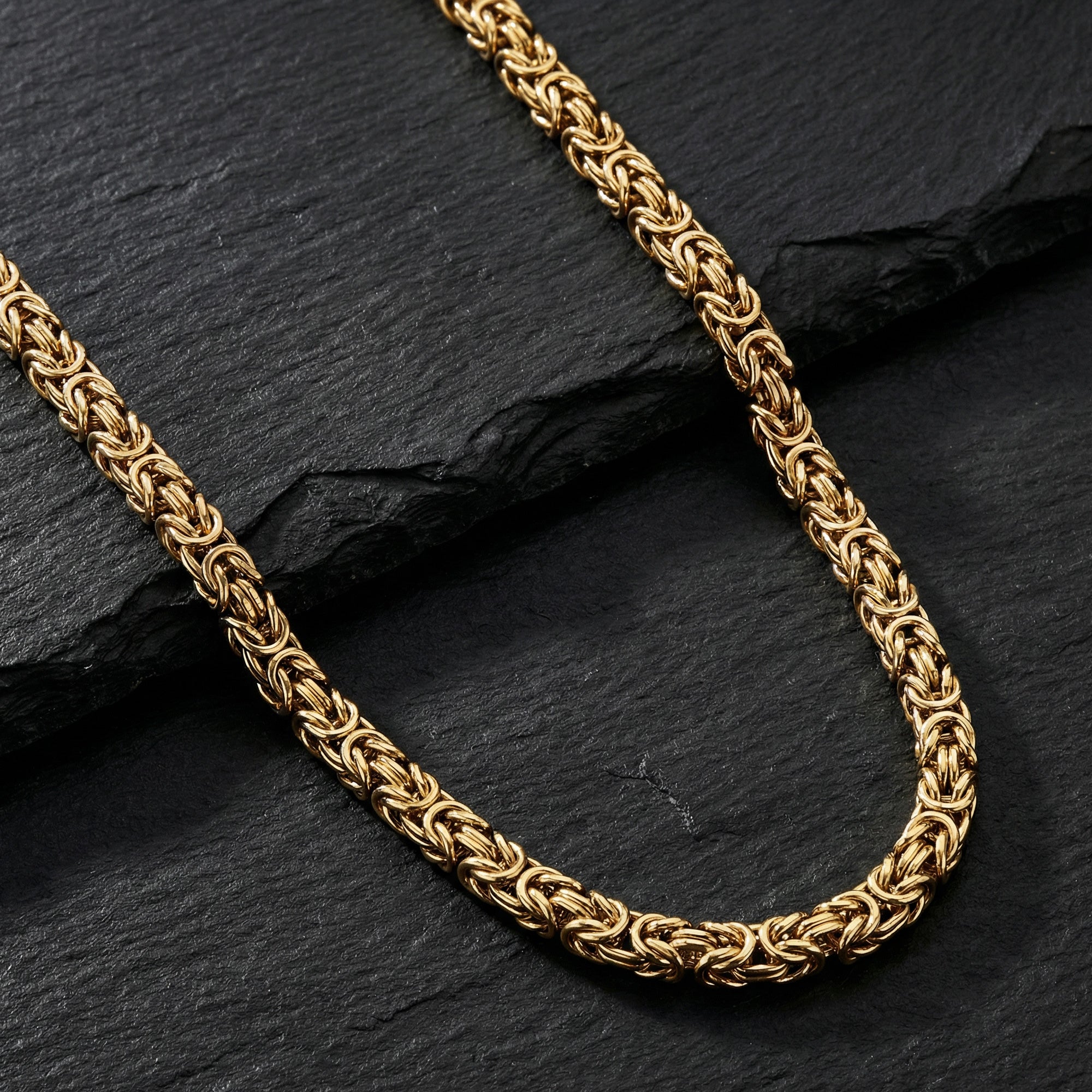 Save Brave Byzantine Chain Gold Steel Necklace On Black Slate Surface