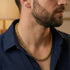 Side View Man Wearing Save Brave Byzantine Chain Gold Steel Necklace