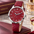 Gregio Porto Grace marsala watch on a table with a leather bound book.