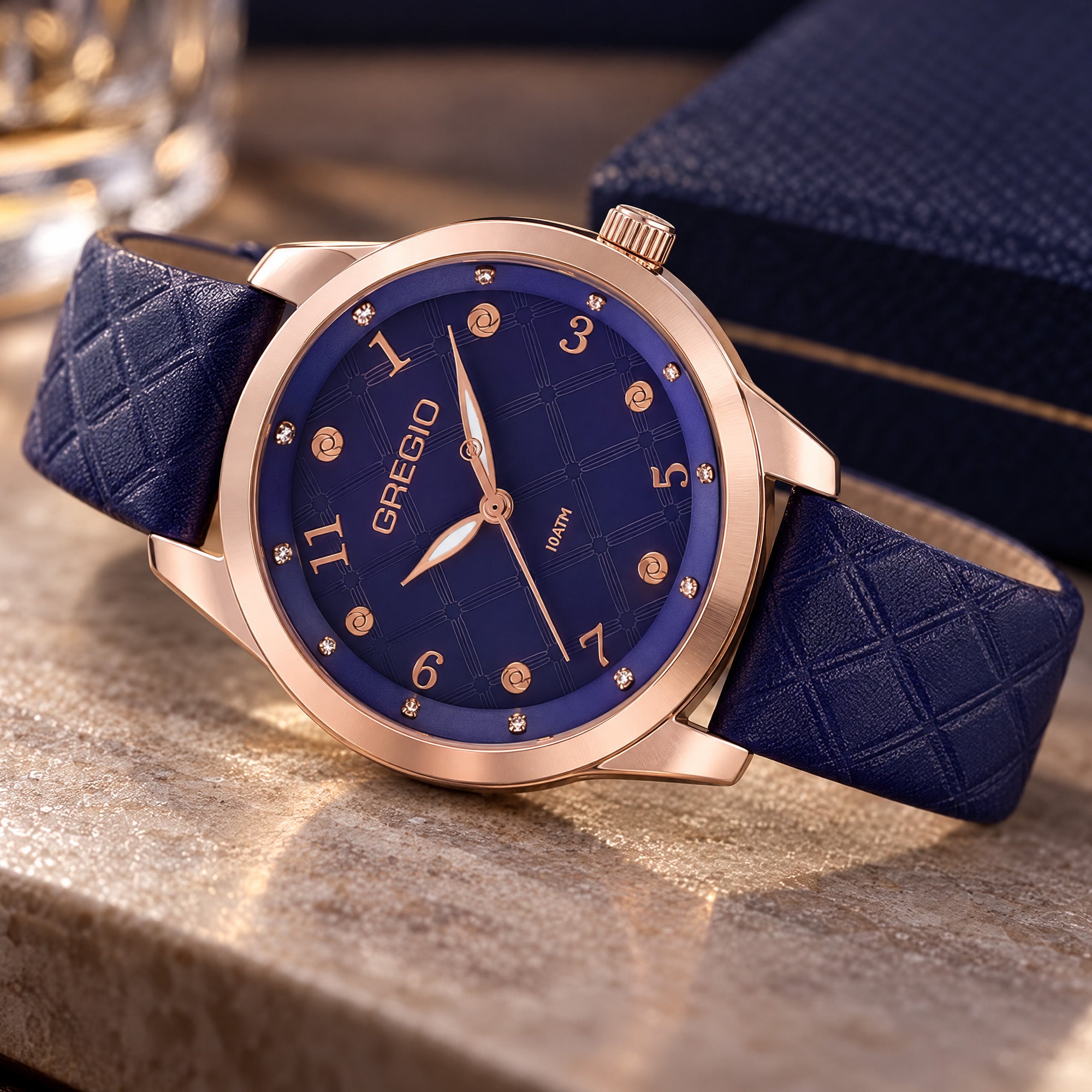 Gregio Porto Grace olive watch on a marble table with a leather bound box.
