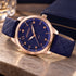 Gregio Porto Grace olive watch on a marble table with a leather bound box.