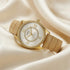 Guess Broadway gold ladies dress watch on soft cream fabric.