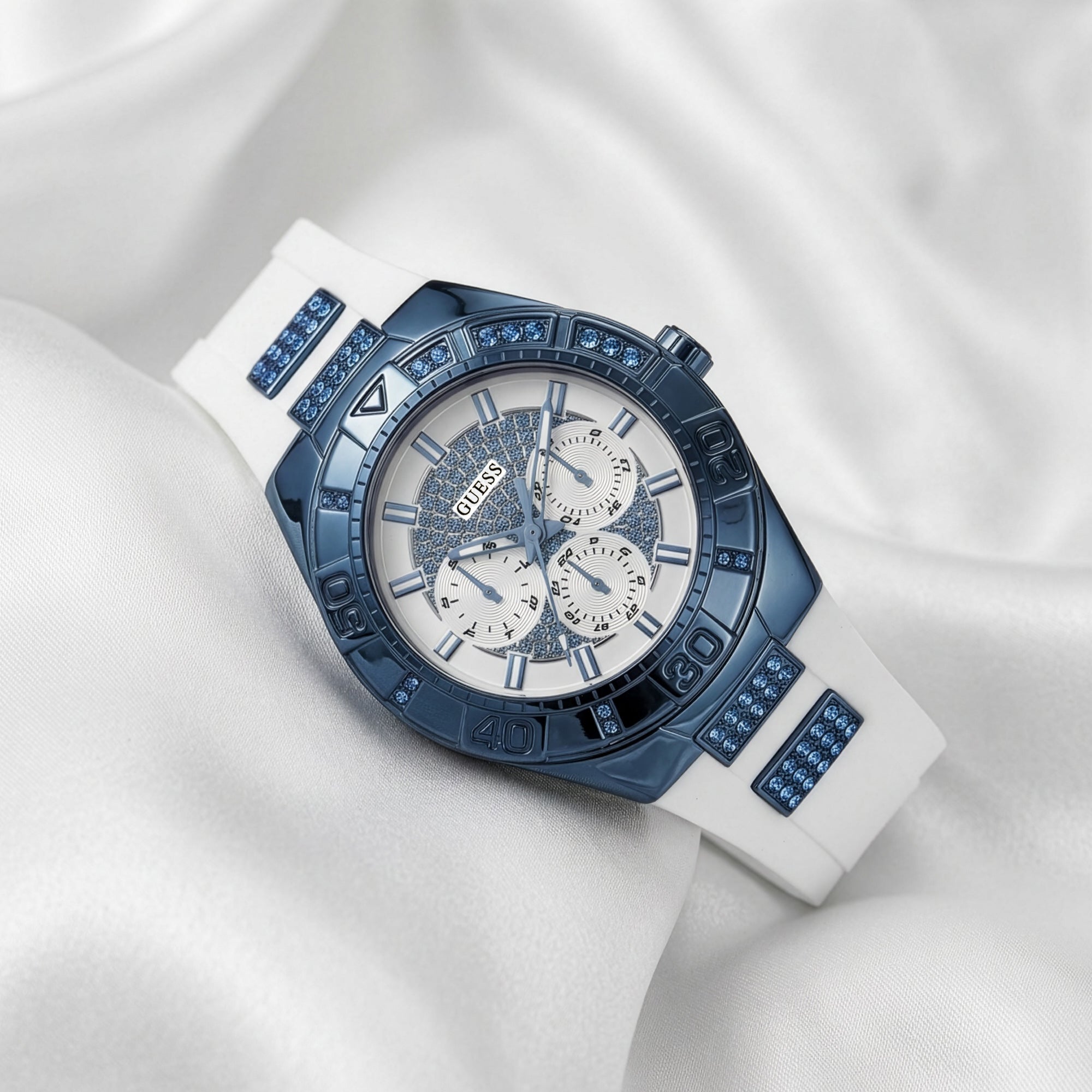 Guess Luna sky blue ladies sport watch on white fabric.