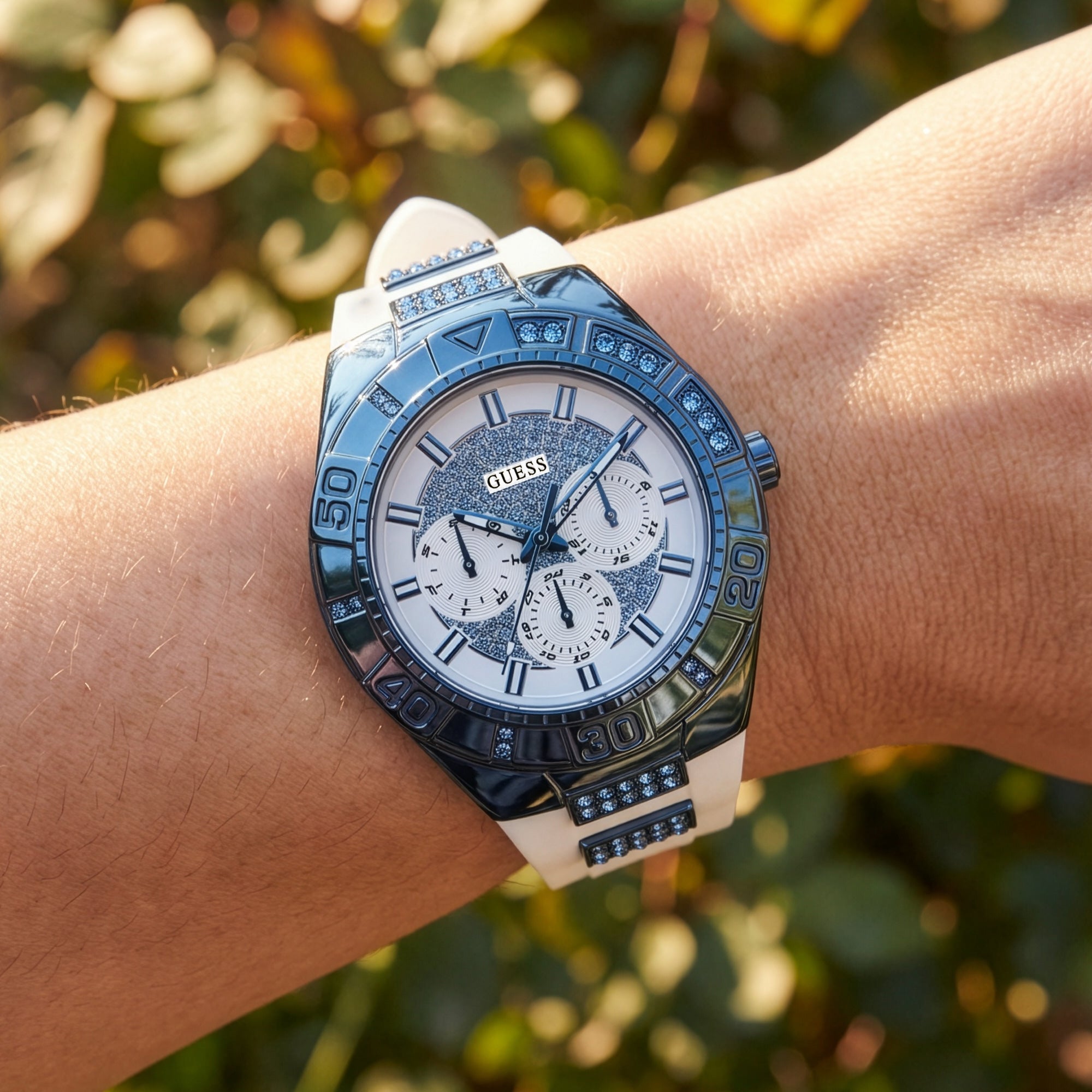 Woman wearing Guess Luna sky blue ladies sport watch.