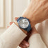 Woman wearing Guess Mini Sunrise sky blue ladies sport watch.