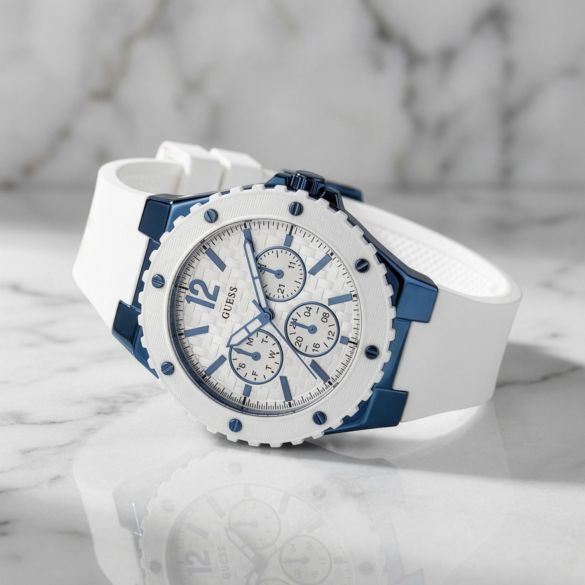 Guess Overdrive sky blue ladies sport watch on white marble background.