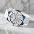 Guess Overdrive sky blue ladies sport watch on white marble background.