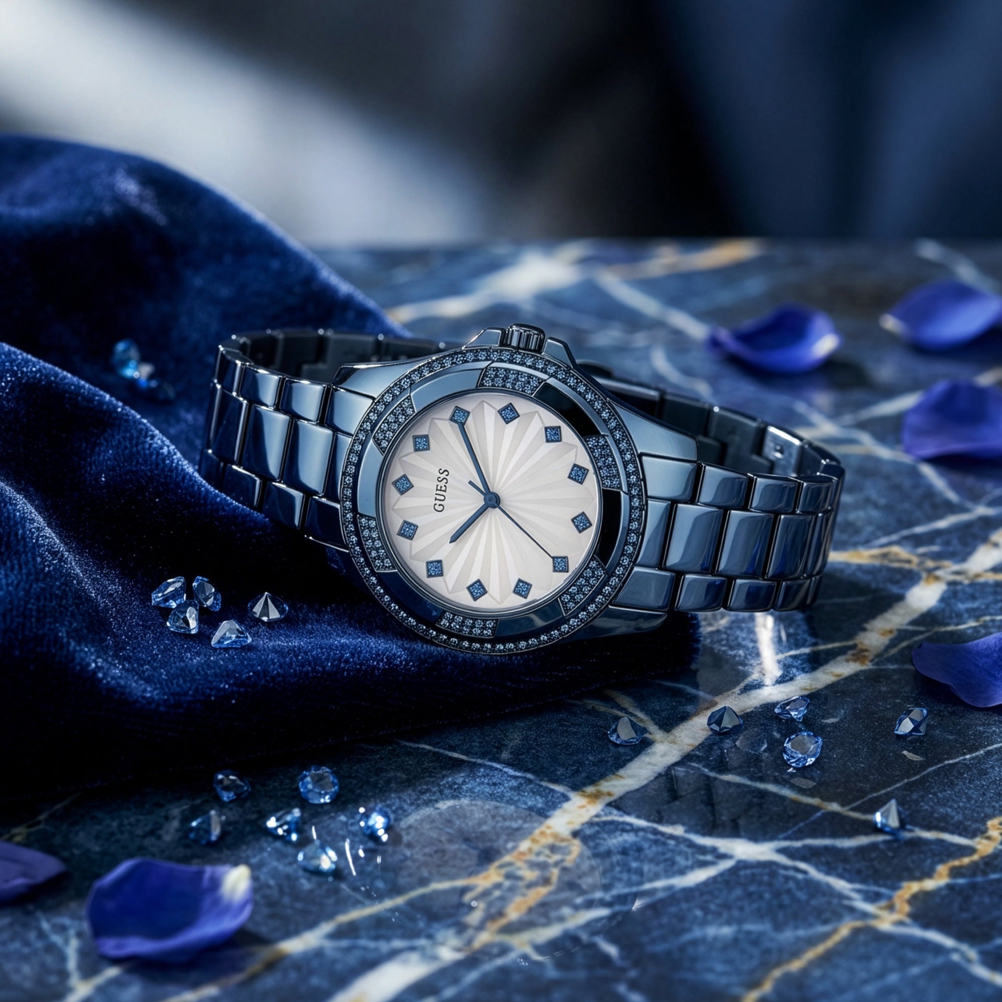 Guess Pinwheel sky blue ladies sport watch on blue marble table with gemstones.