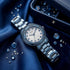 Guess Pinwheel sky blue ladies sport watch on fabric with gemstones.