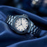 Guess Pinwheel sky blue ladies sport watch on blue fabric.