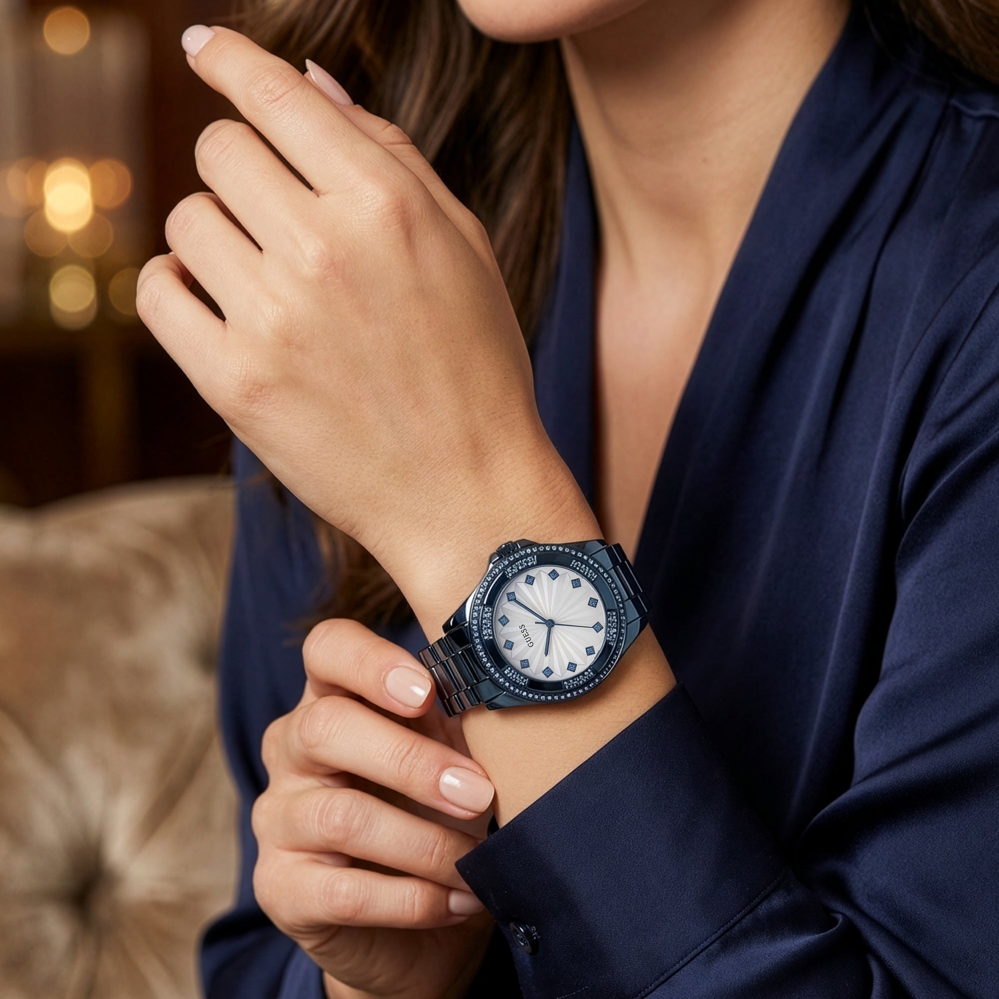 Woman wearing Guess Pinwheel sky blue ladies sport watch.