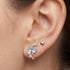 Close-up of woman wearing Engelsrufer heart & moon mismatch sterling silver earrings.