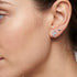 Woman wearing Engelsrufer heart & moon mismatch sterling silver earrings.